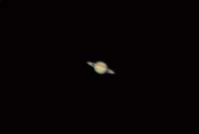 Saturn and its rings seen through a small telescope