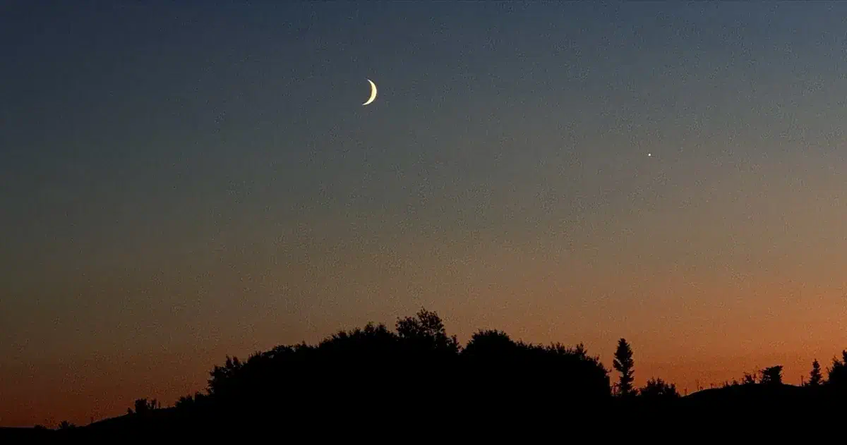 The Moon in the night sky with the planet Venus nearby